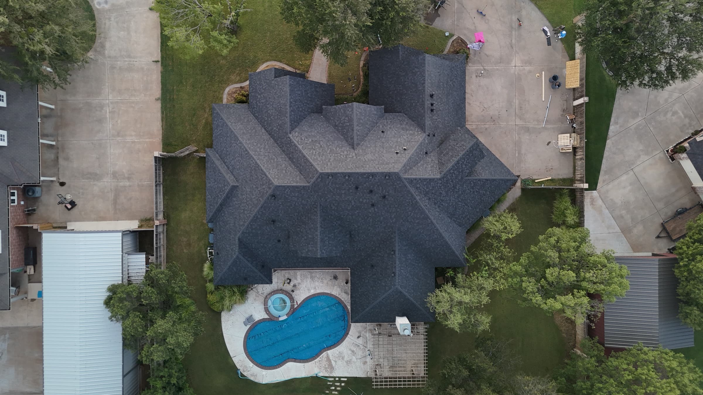 Finished roof replacement with pool in background